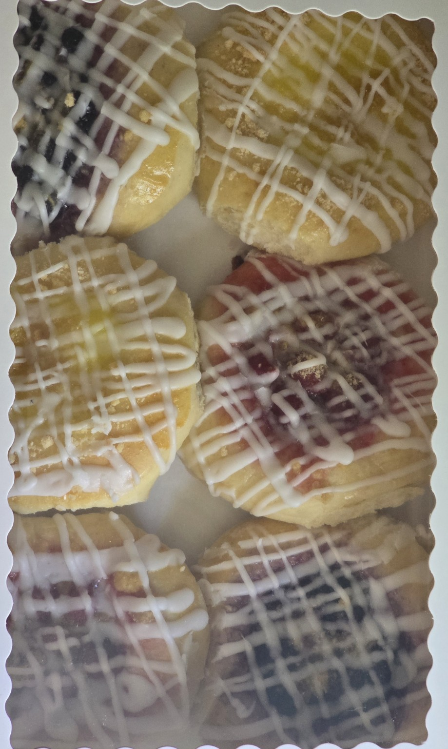 A boxed half dozen of fruit kolaches finished with icing