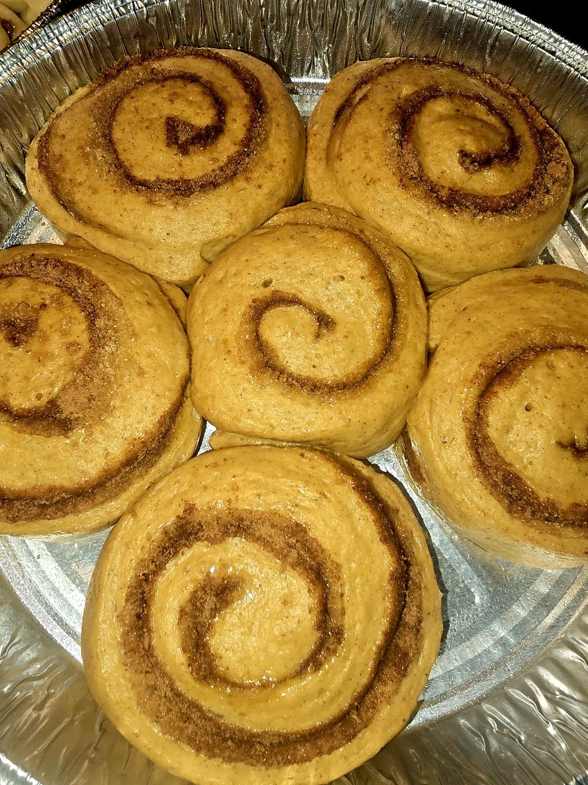 Pumpkin spice latte rolls in the pan before icing