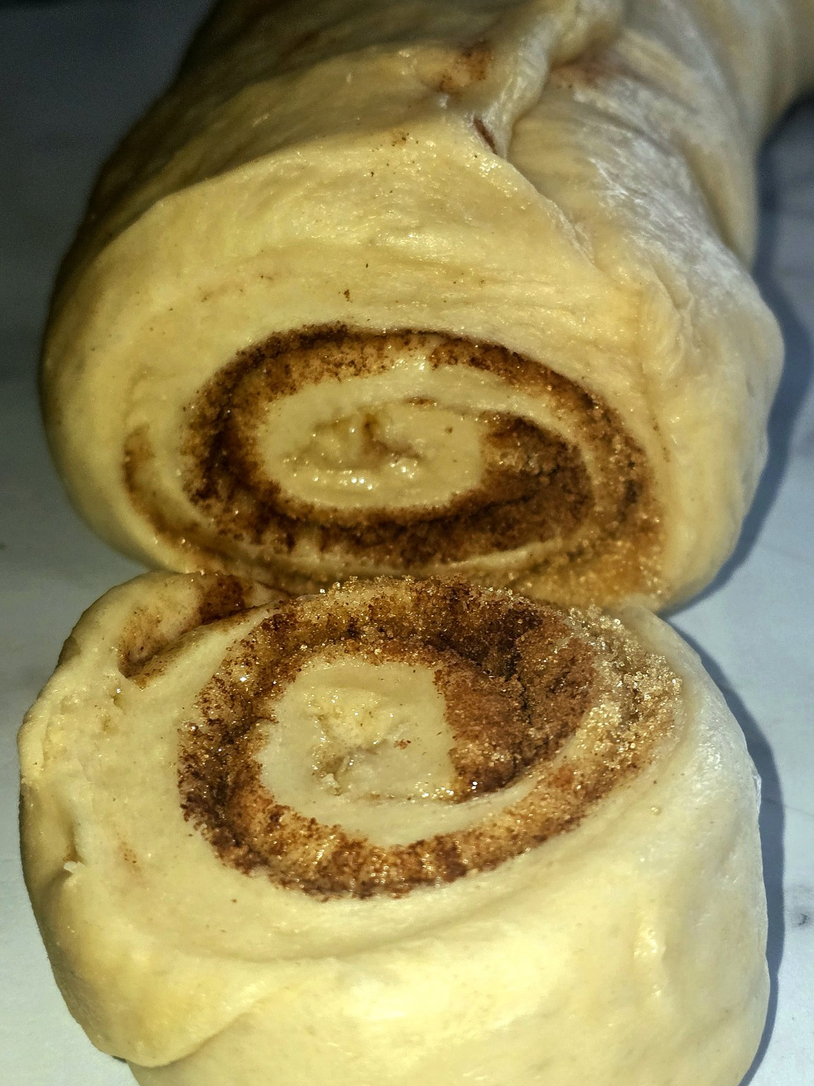 Cinnamon roll cross-section showing the spiral of brown sugar and spice